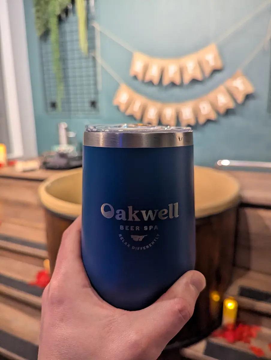 A close up of a beer at Oakwell Beer Spa with the spa tub in the background